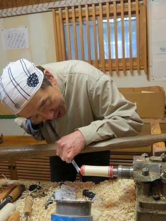 Naruko craftsman making kokeshi